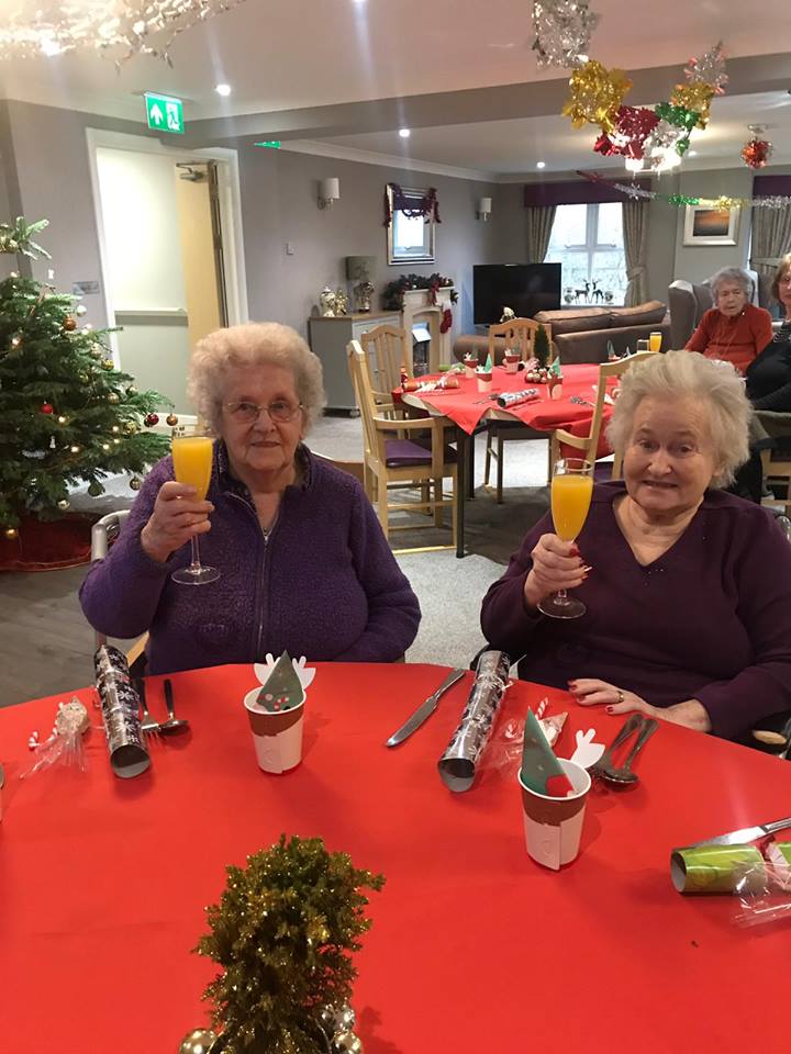 Doreen and Trudy toasting to another merry Christmas at Magnolia House